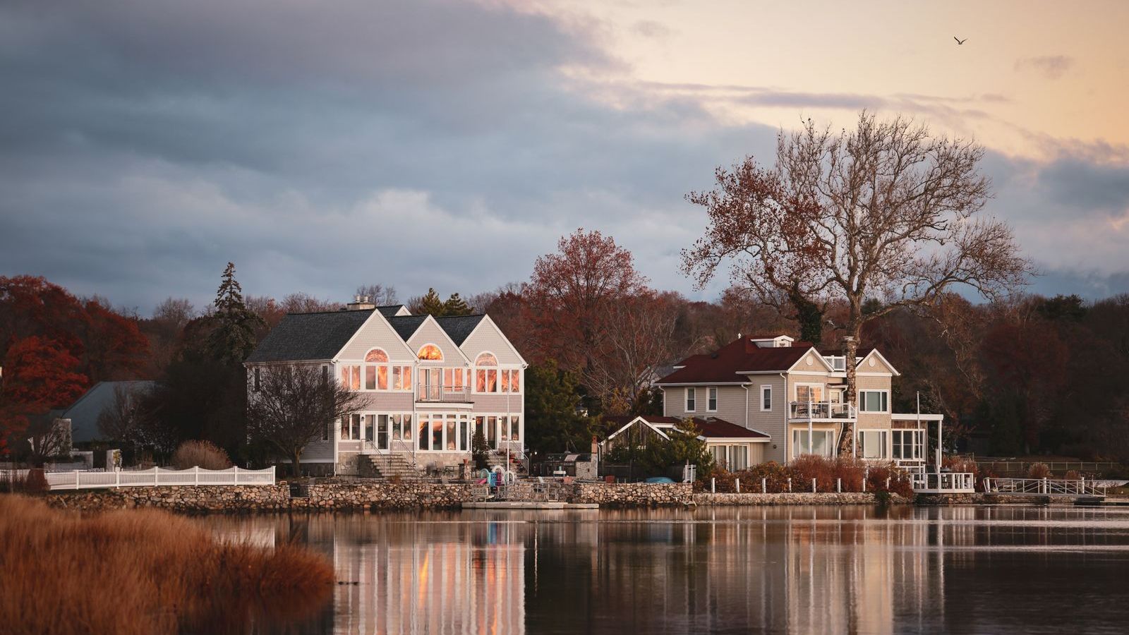 New England homes along the water at dusk, representative of Newfield, Stamford CT
