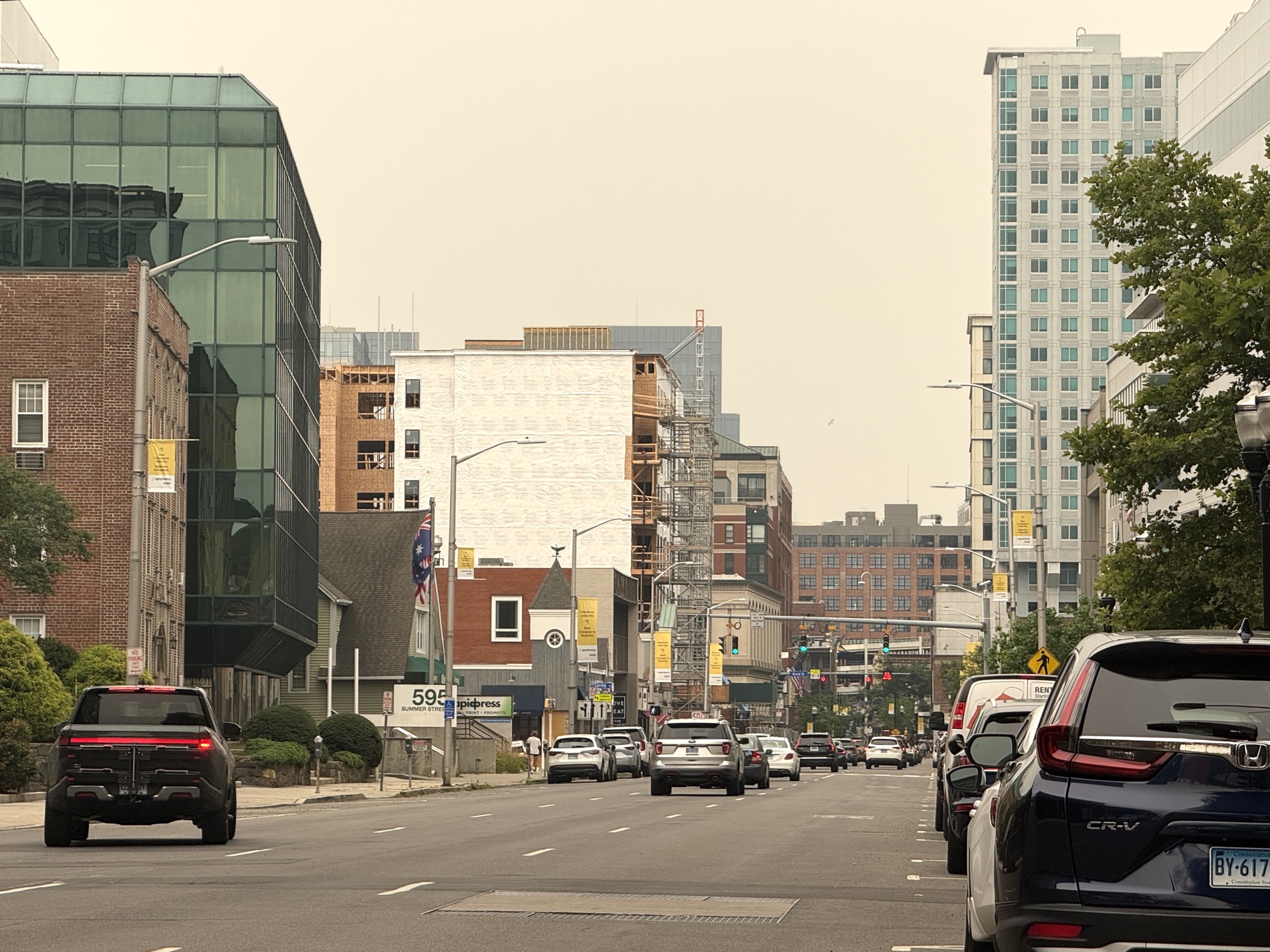 Summer Street in downtown Stamford, CT — new apartment construction rising over tree-lined blocks; the streets your local Stamford realtor near me, John Restrepo, works every day
